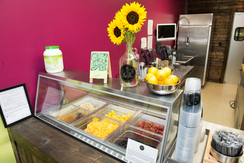 Sunflowers and fresh fruits and veggies greet Juice Bar customers. Sunflowers and fresh fruits and veggies greet Juice Bar customers.