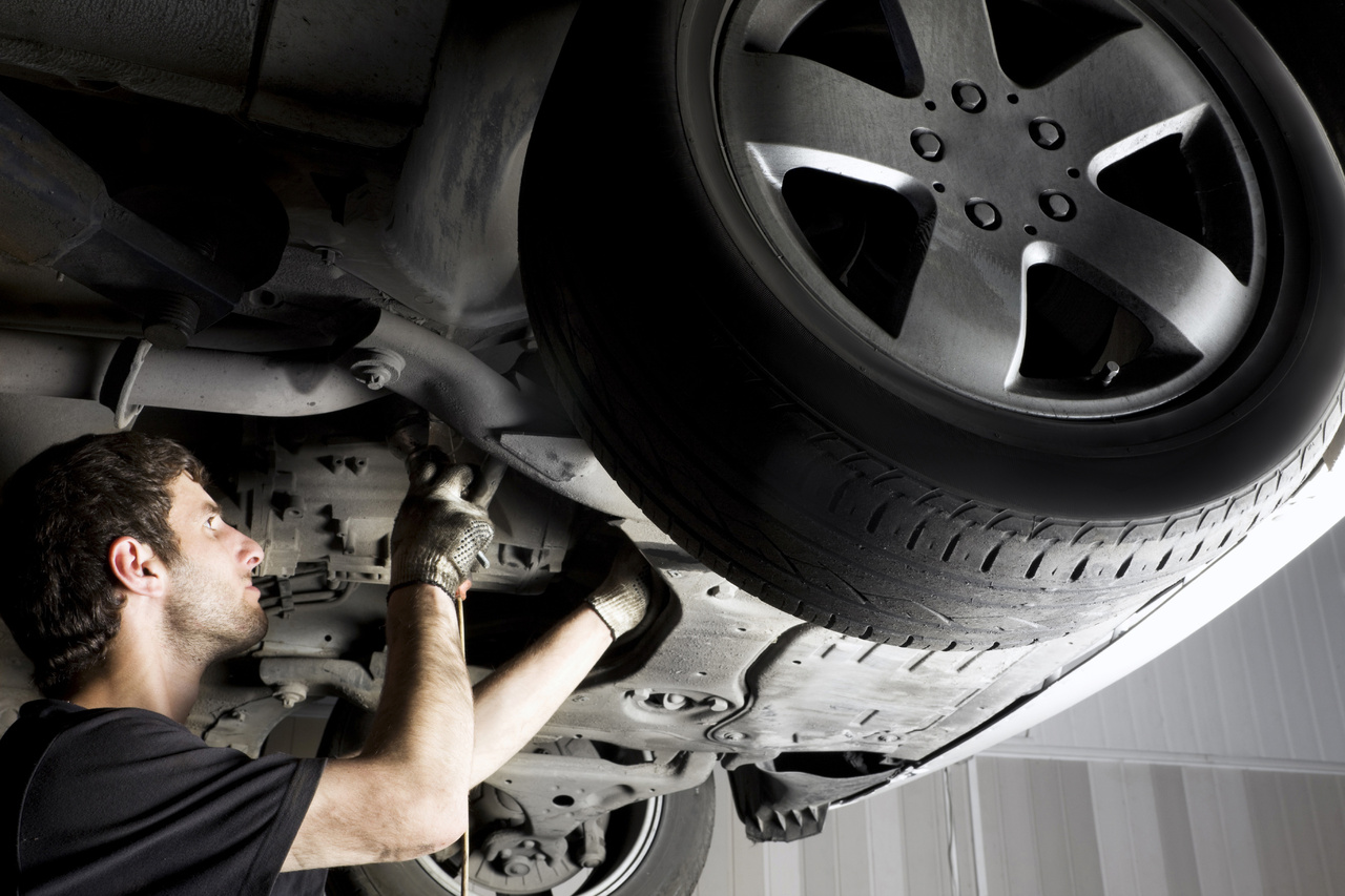  Service technician inspecting tire