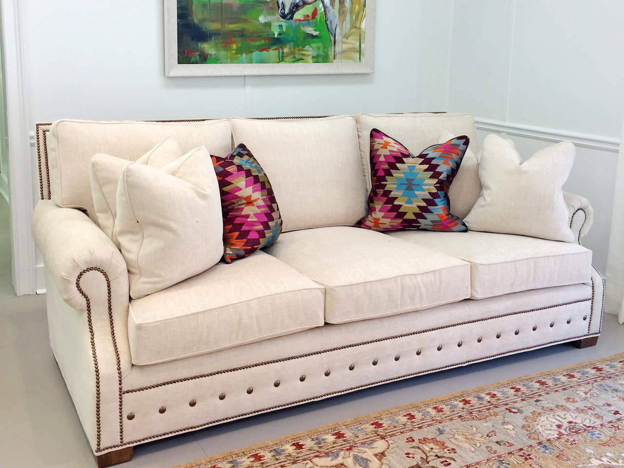 Add colorful pillows to a white couch for depth. White couch StyleBlueprint Atlanta