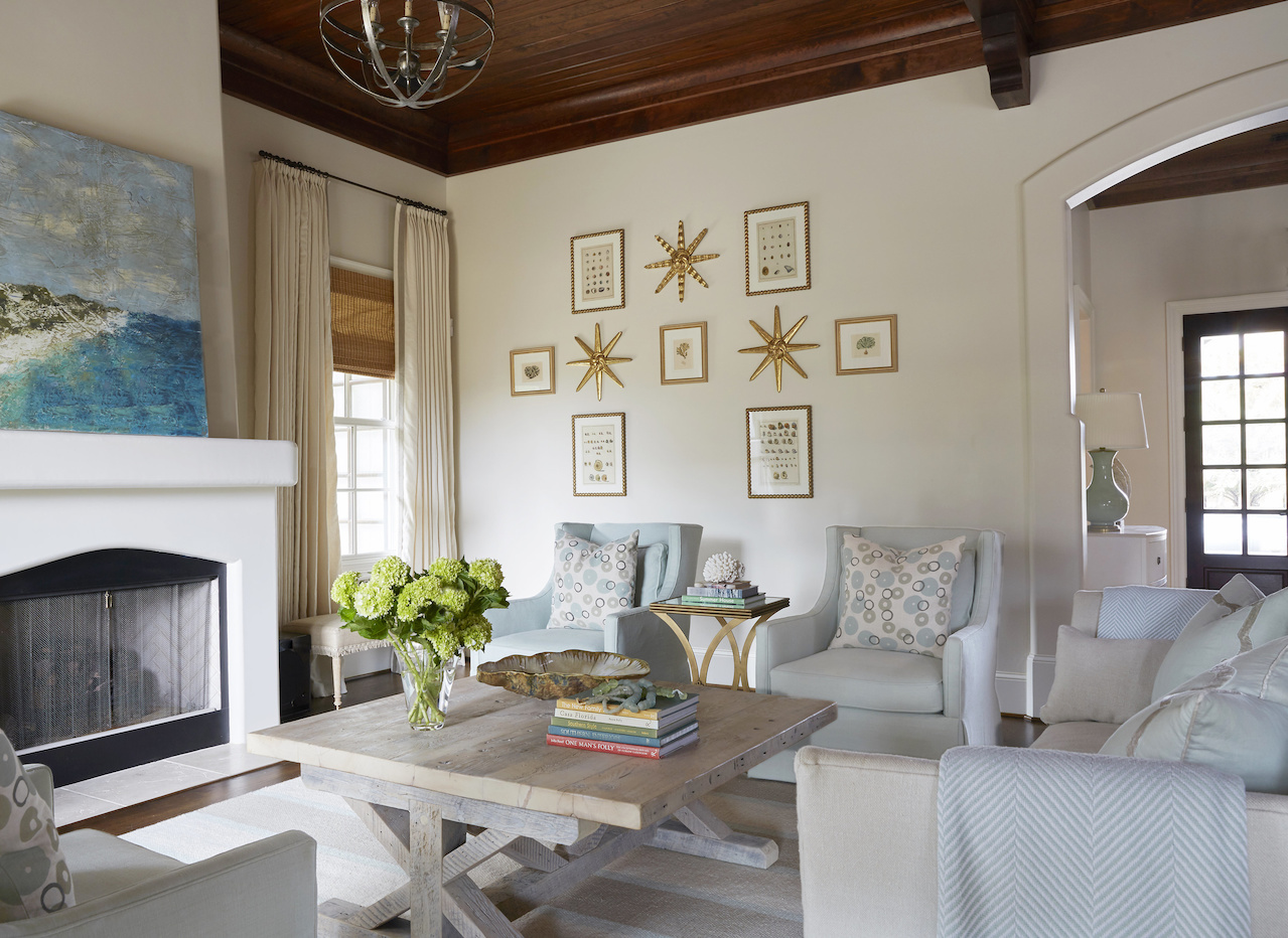 The three antique gilded starbursts are from Foxglove Antiques & Galleries in Atlanta and the framed pieces surrounding it are antique prints of shells from Arceneaux Gallery in Birmingham. "I loved making it soft and fresh for the beach," says Libby of this beach house, which underwent a total makeover. This living room was once all red, gold and chocolate.
