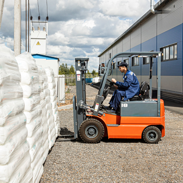 close up of worker on forklift moving materials