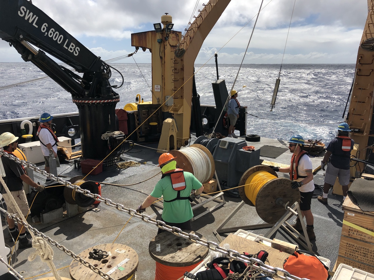 The entire Sette deck crew and CRP staff member, Erik Norris, were involved in the recovery and redeployment of the PMEL listening station device. The recovered recording device was deployed in July during our 2017 HICEAS project, https://www.fisheries.noaa.gov/feature-story/heading-high-seas-hawaiian-islands-cetacean-and-ecosystem-assessment-survey, and today a new recording device is lowered into the water during the redeployment. For more information on the acoustic recorder, check out https://www.pmel.noaa.gov/acoustics/noaanps-ocean-noise-reference-station-network and https://www.st.nmfs.noaa.gov/feature-news/acoustics. Photo: NOAA Fisheries/Marie Hill.