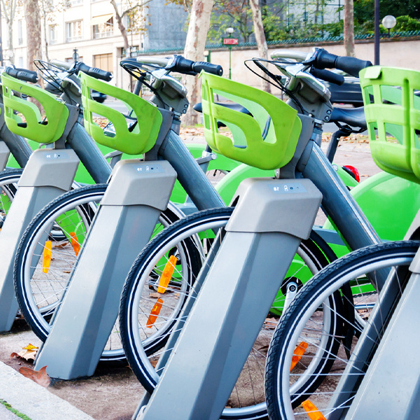 electric bicycles with green baskets racked