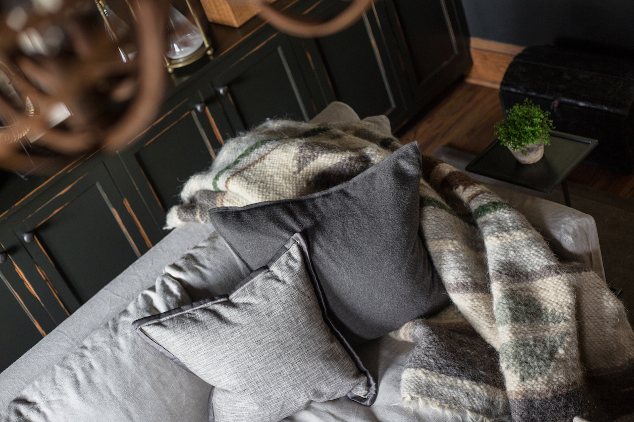 This dark and masculine space is softened with lighter colored fabrics, plush throws and pillows. This dark and masculine space is softened with lighter colored fabrics, plush throws and pillows.