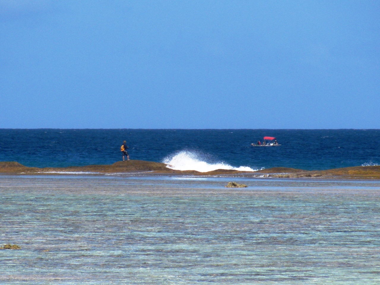 Fishing from the shore and from a boat along the Guam coast. Photo: NOAA Fisheries/Justin Hospital.