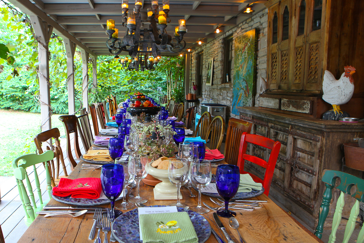 Chandeliers holding candles are used for the outdoor porch