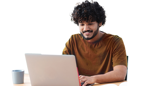 college student smiling working on laptop at desk