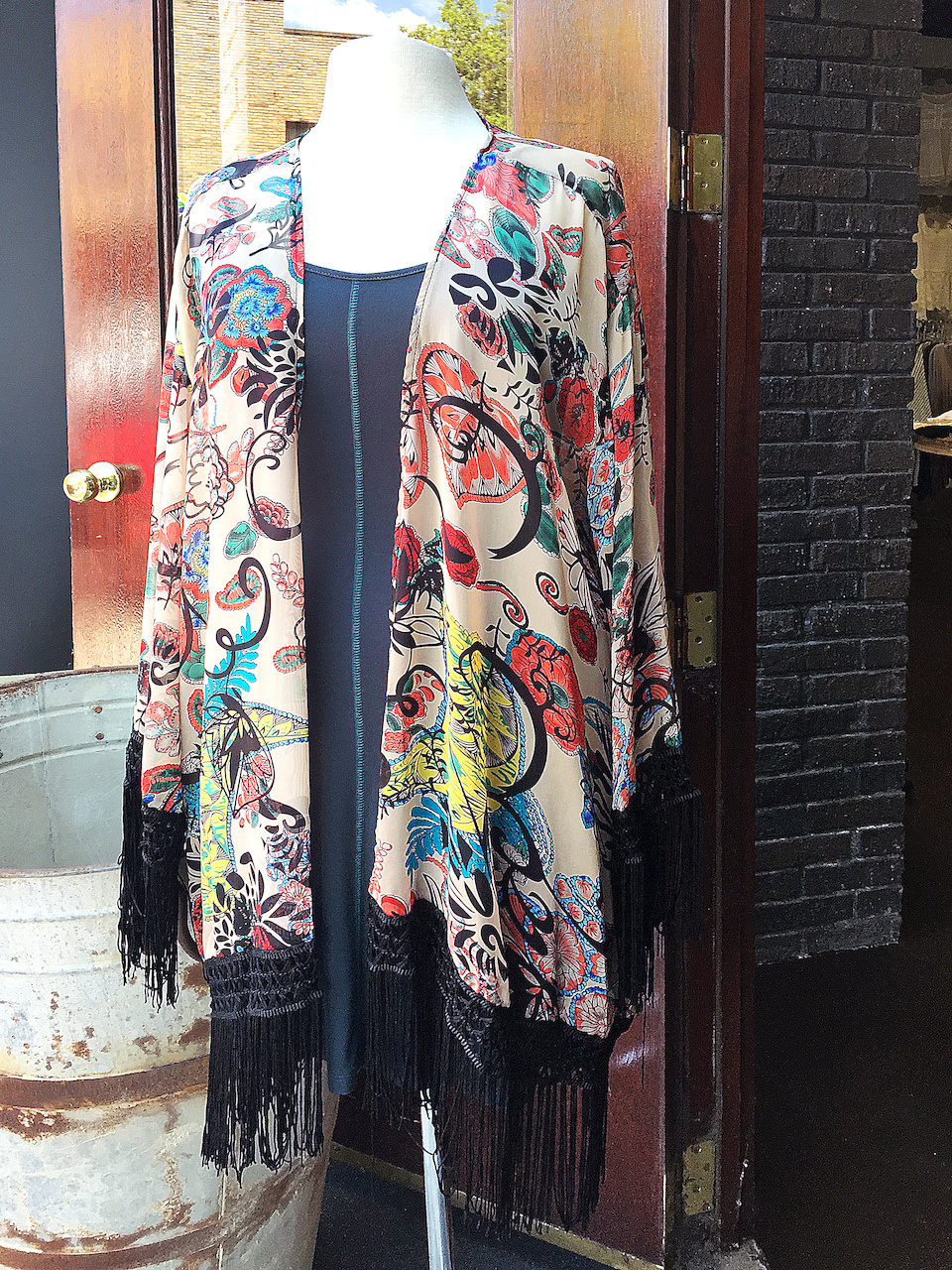 From Ambiance: Multiprint fringe kimono, $44; teal tank dress, $39 From Ambiance: Multiprint fringe kimono, $44; teal tank dress, $39