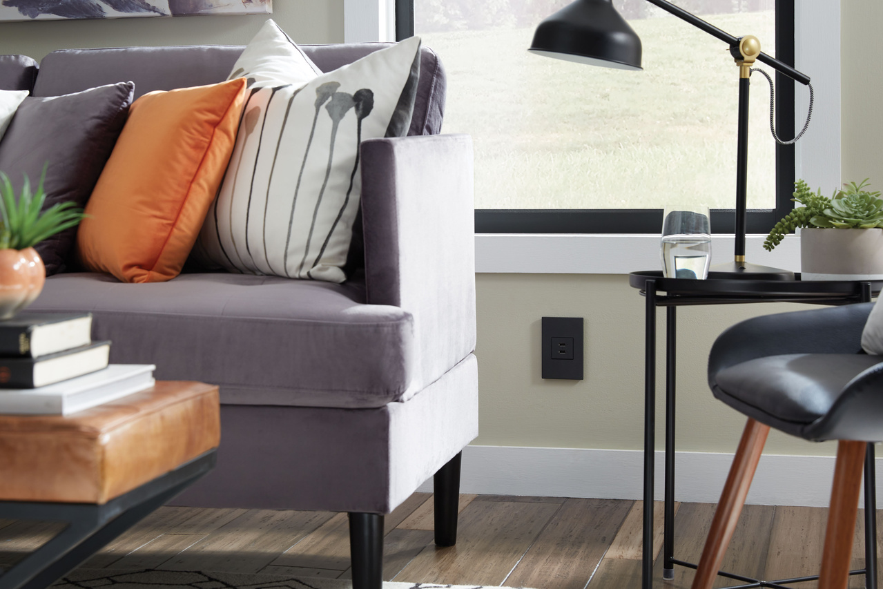 adorne USB Type A/A outlet in graphite with graphite wall plate with graphite wall plate in modern living room