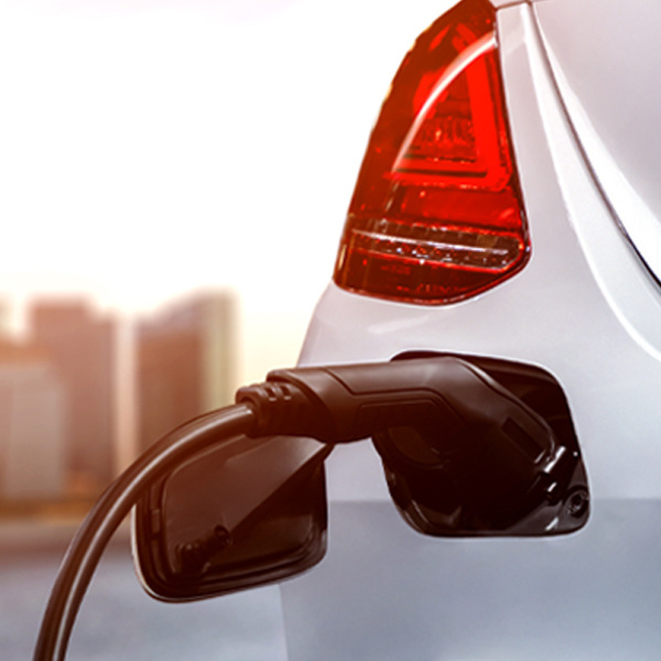 black EV charger charging white car