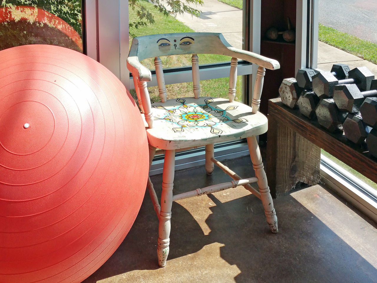 A corner of the sunroom features a colorfully decorated yoga lover's chair. A corner of the sunroom features a colorfully decorated yoga lover's chair.