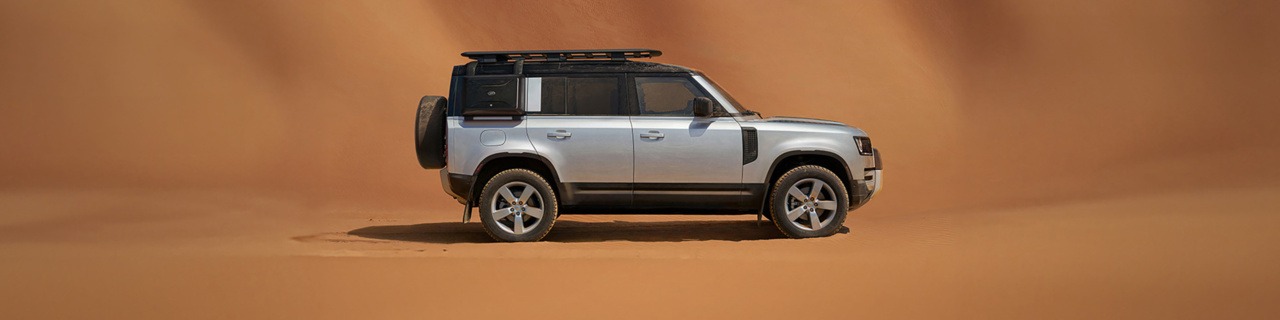 Defender 110 on a sand background