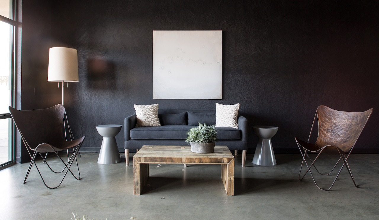 Even with natural light and simple contrasts of color, the dark walls of the Flow Cyrotherapy lobby provide a sedate space. Even with natural light and simple contrasts of color, the dark walls of the Flow Cyrotherapy lobby pull guests into a sedate space.
