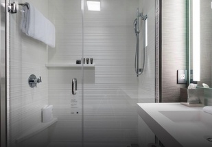 adorne Collection usb outlet with magnesium designer wall plate in living room next to couch and tablet on side table