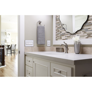 adorne Collection mirror white wall plate installed next to bathroom sink on beige wall with tan accents