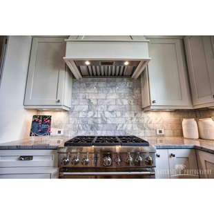 adorne Collection mirror white wall plate next to stainless steel kitchen range