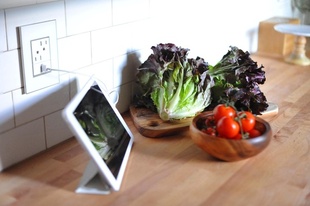 adorne mirror white wall plate with outlet and half size USB outlet installed above kitchen counter next to tablet and tray of vegetables