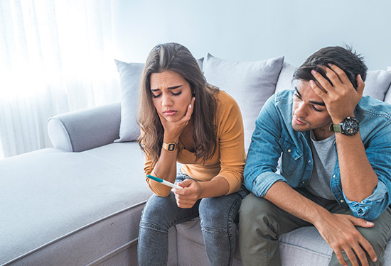 couple frustrated at pregnancy test