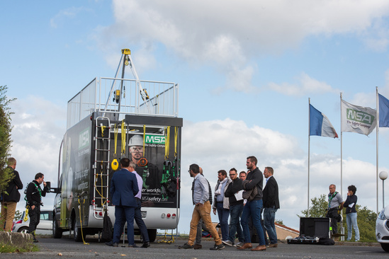 Safety managers gather around the MSA training vehicle